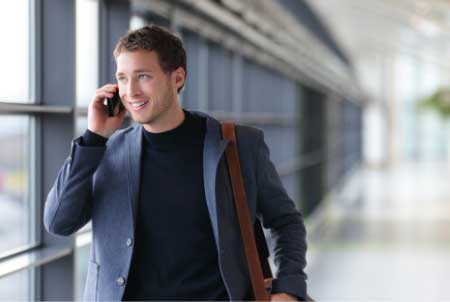 Man talking on phone scheduling his consulation